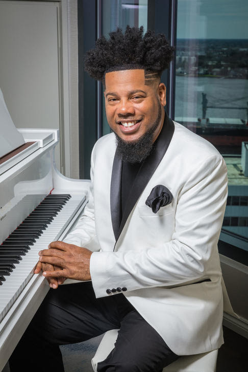 Dr. Earl Bynum seated at piano